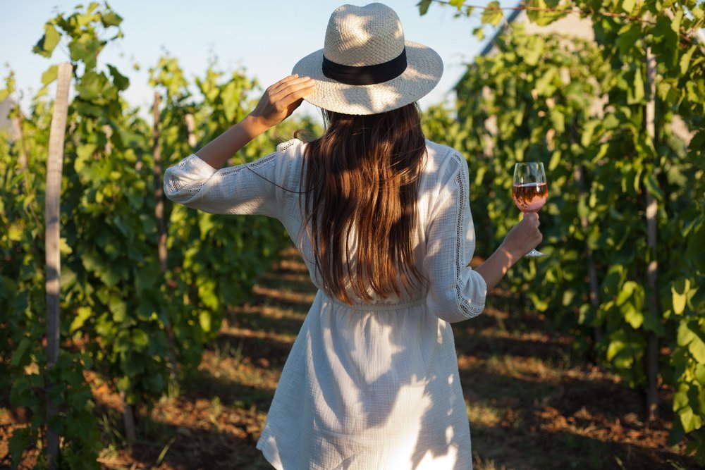 Woman enjoying fine wine at a vineyard