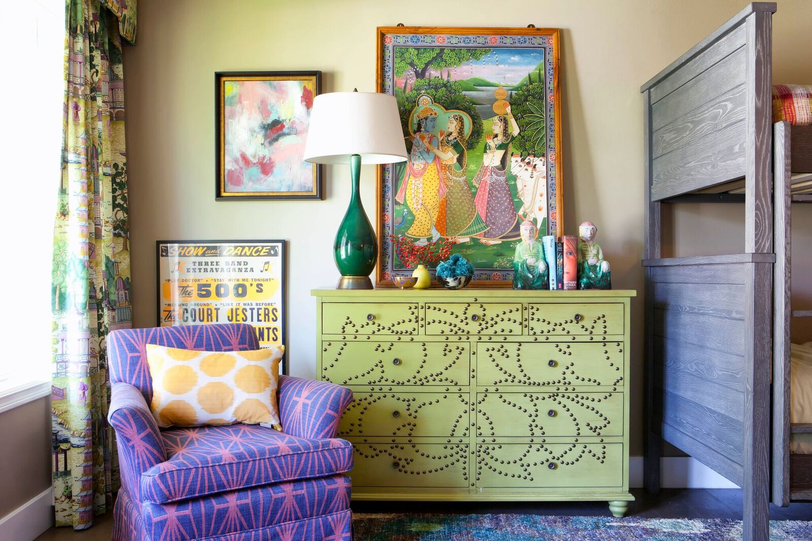 Green dresser with purple chair and large scale art.